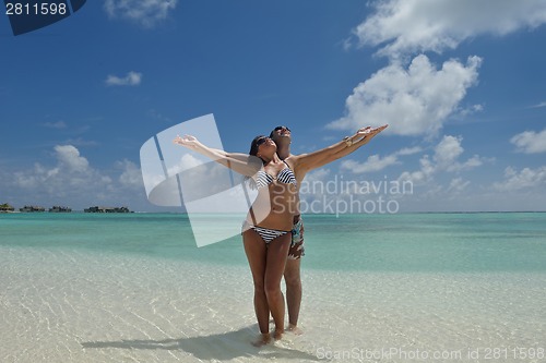Image of happy young couple have fun on beach