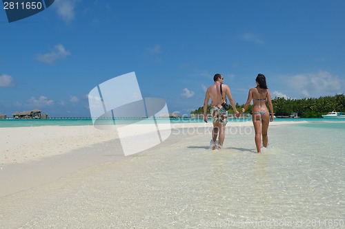 Image of happy young couple have fun on beach