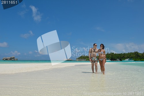 Image of happy young couple have fun on beach