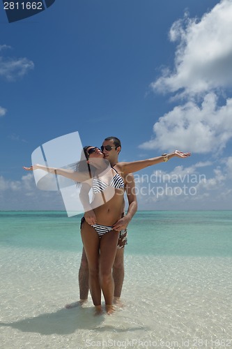 Image of happy young couple have fun on beach