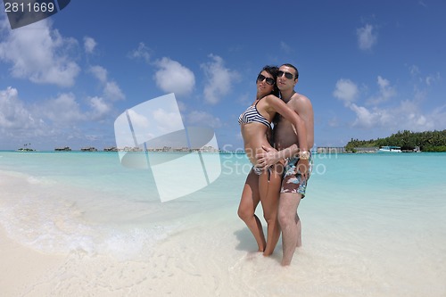 Image of happy young couple have fun on beach