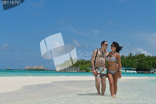 Image of happy young couple have fun on beach