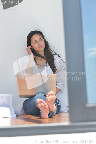 Image of relaxed young woman at home