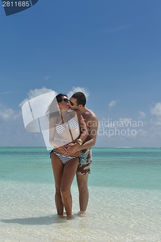 Image of happy young couple have fun on beach