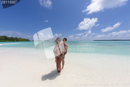 Image of happy young couple have fun on beach