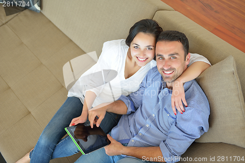 Image of couple at home using tablet computer