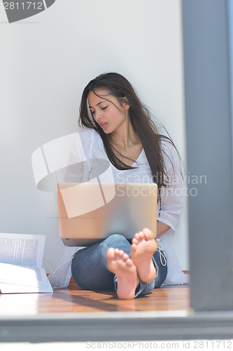 Image of relaxed young woman at home