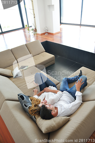 Image of couple at home using tablet computer