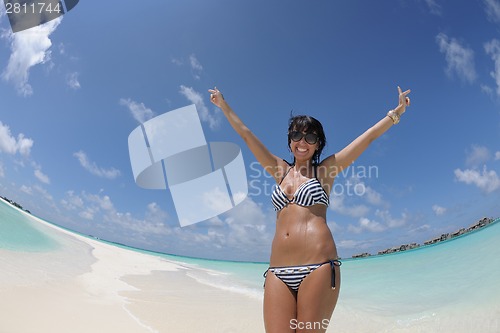 Image of beautiful young woman  on beach have fun and relax