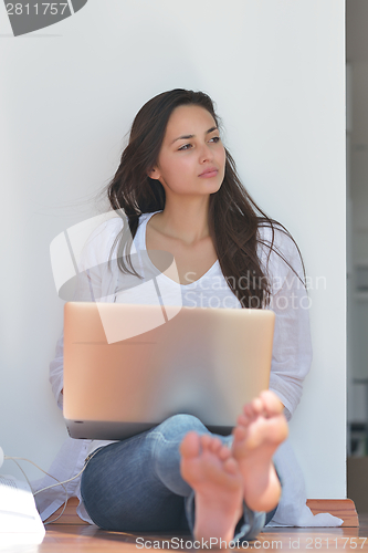 Image of relaxed young woman at home