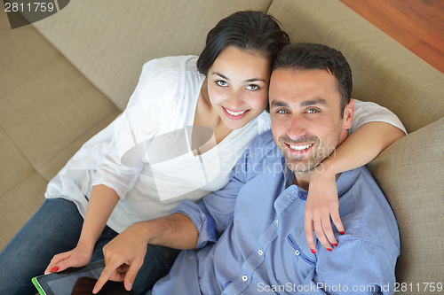 Image of couple at home using tablet computer