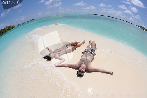 Image of happy young couple have fun on beach