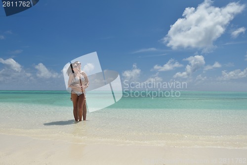 Image of happy young couple have fun on beach