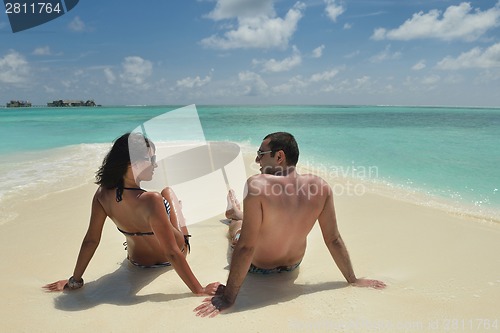 Image of happy young couple have fun on beach