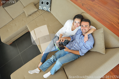 Image of couple at home using tablet computer