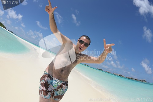 Image of young man have fun and relax on beach