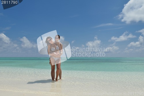 Image of happy young couple have fun on beach