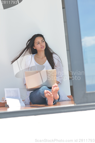 Image of relaxed young woman at home