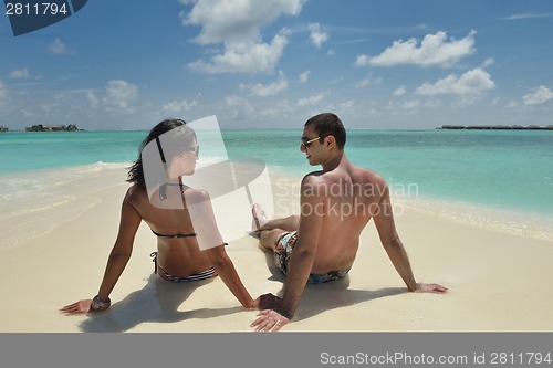 Image of happy young couple have fun on beach