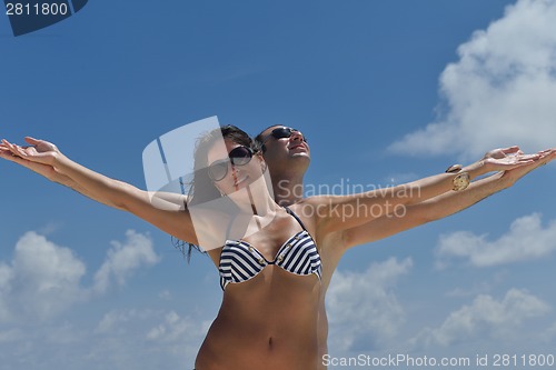 Image of happy young couple have fun on beach