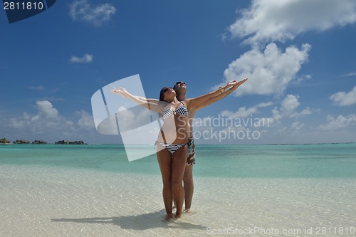 Image of happy young couple have fun on beach