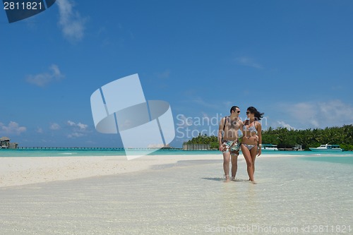 Image of happy young couple have fun on beach