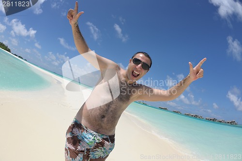 Image of young man have fun and relax on beach
