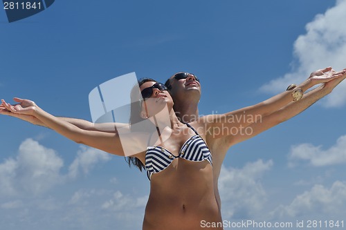 Image of happy young couple have fun on beach
