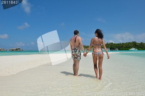 Image of happy young couple have fun on beach