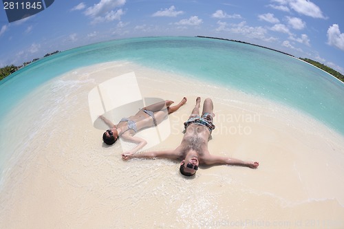 Image of happy young couple have fun on beach