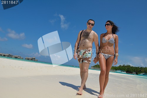 Image of happy young couple have fun on beach