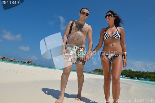 Image of happy young couple have fun on beach