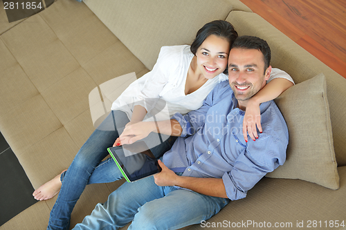 Image of couple at home using tablet computer