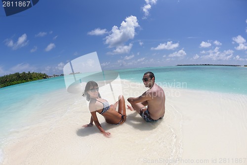 Image of happy young couple have fun on beach