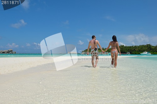 Image of happy young couple have fun on beach