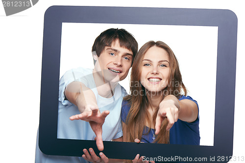 Image of Happy couple looking through tablet frame