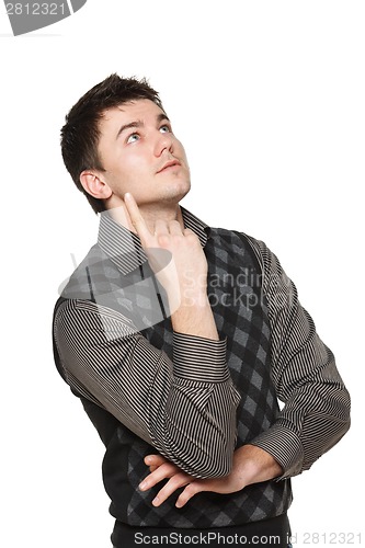 Image of Surprised young man looking and pointing up