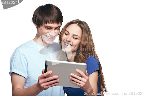 Image of Closeup of young couple laughing while websurfing on internet