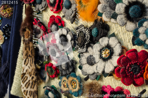 Image of female flower brooches from materials bead feather 