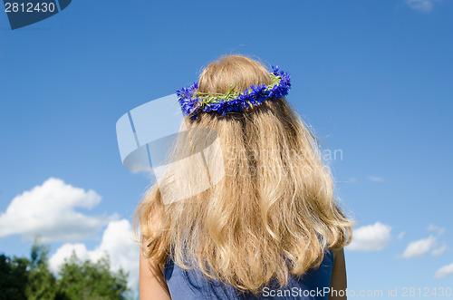 Image of woman wavy hair and flower crown on sky background