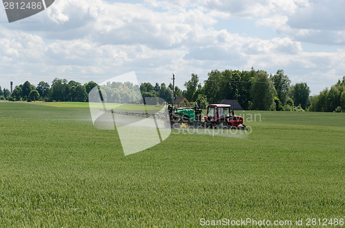 Image of special equipment fertilize wheat crop field 