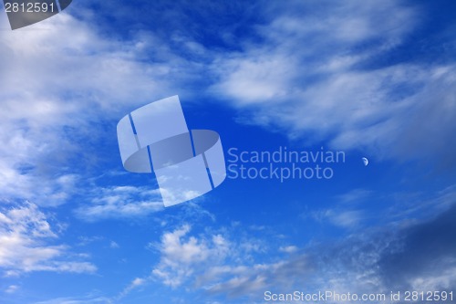 Image of Evening blue sky with clouds and moon
