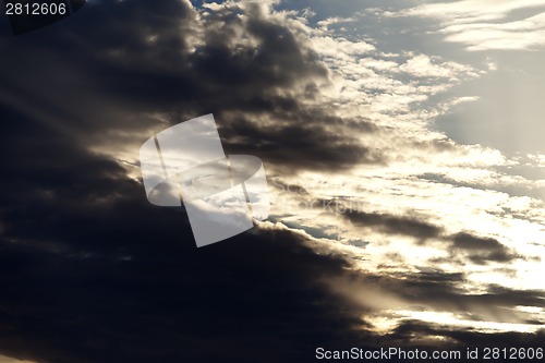 Image of Dark storm clouds and sunlight sky