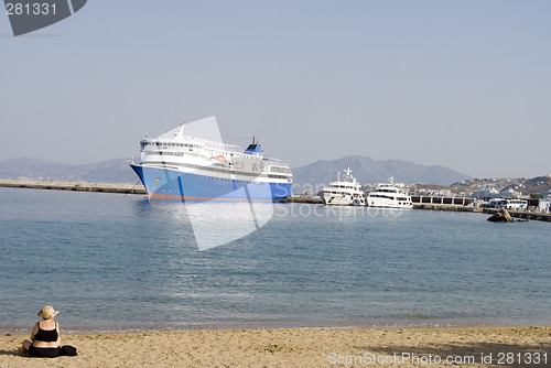 Image of woman on beach harbor with boats