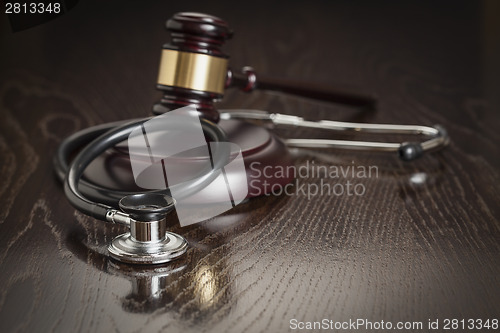 Image of Gavel and Stethoscope on Reflective Table