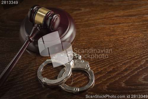 Image of Gavel and Pair of Handcuffs on Table