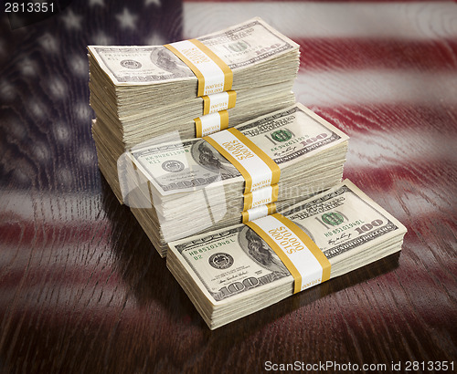 Image of Thousands of Dollars with Reflection of American Flag on Table