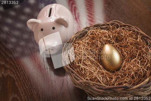 Image of Golden Egg, Nest and Piggy Bank with American Flag Reflection