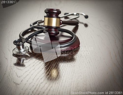 Image of Gavel and Stethoscope on Reflective Table