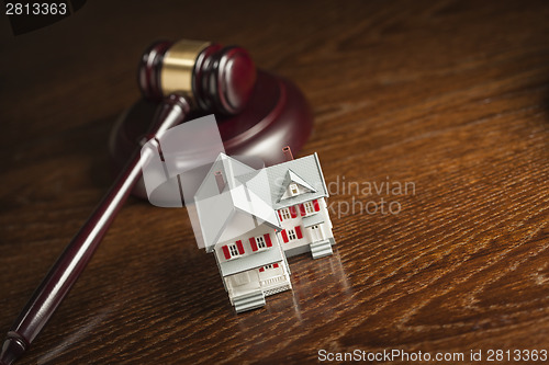 Image of Gavel and Small Model House on Table